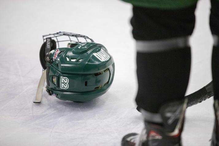 An OHIO Hockey helmet rests on the ice