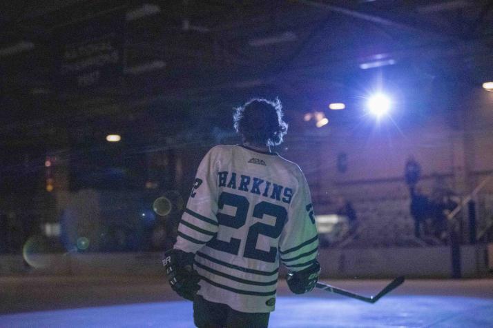 OHIO Hockey player is lit from behind on the ice