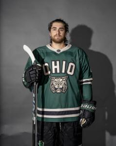 Tommy Klopfer posing for a photo in his hockey jersey.