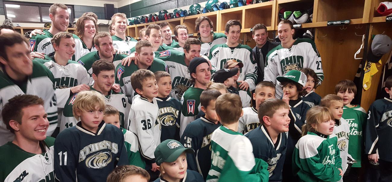The OHIO hockey team poses with children from the community