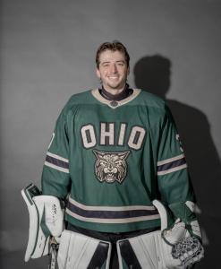 Scott Bird posing in his jersey, goalie mitts and guards