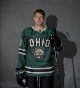 Tj Richey posing in his hockey jersey